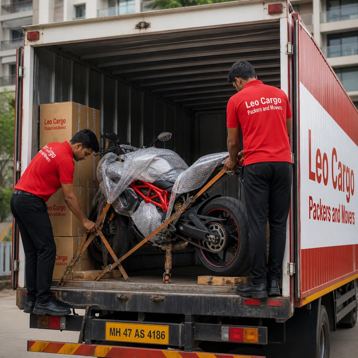 Movers securing a premium sports motorcycle with heavy-duty straps inside the back of a moving truck - Leo Cargo Packers and Movers